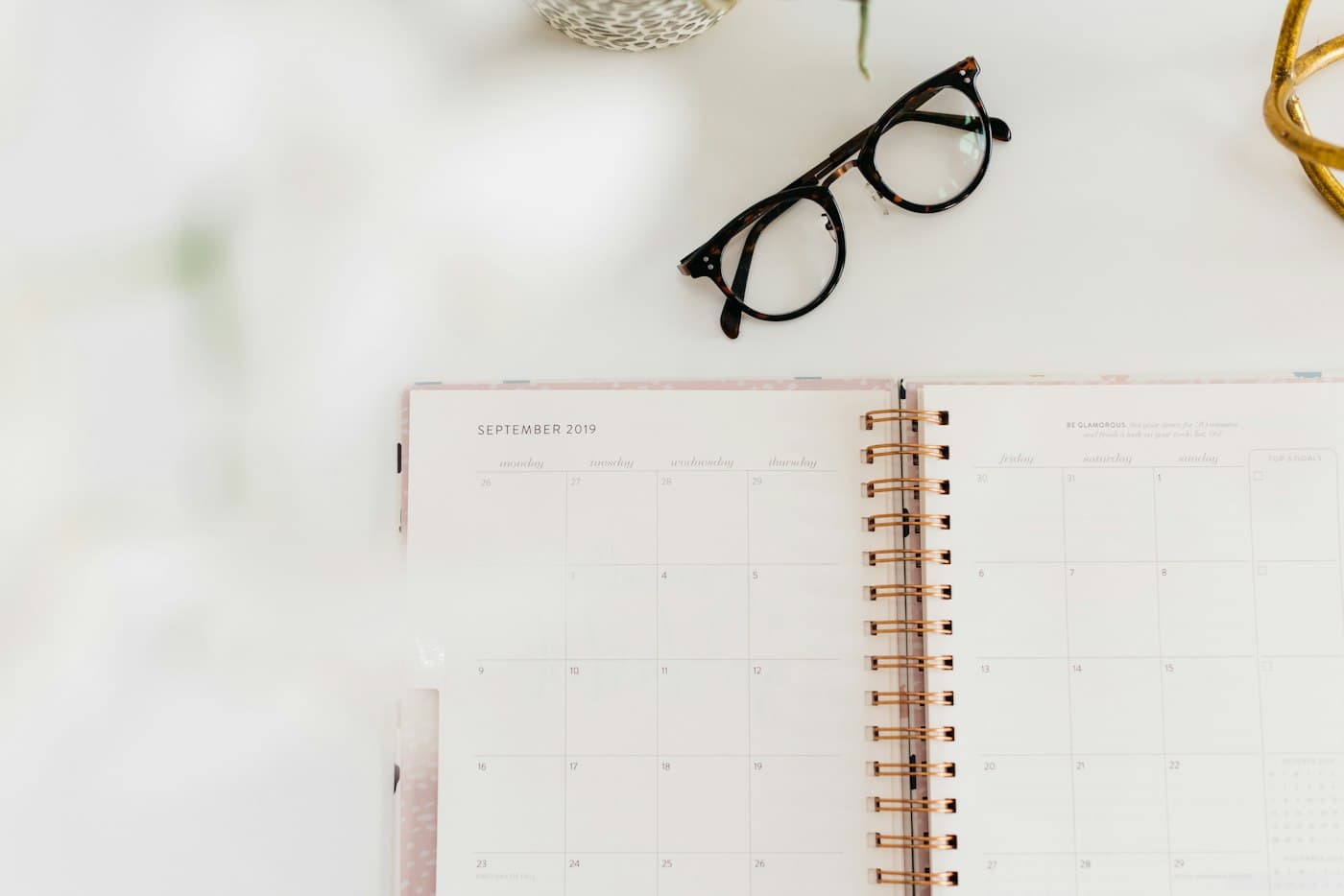 Open monthly planner on a white desk